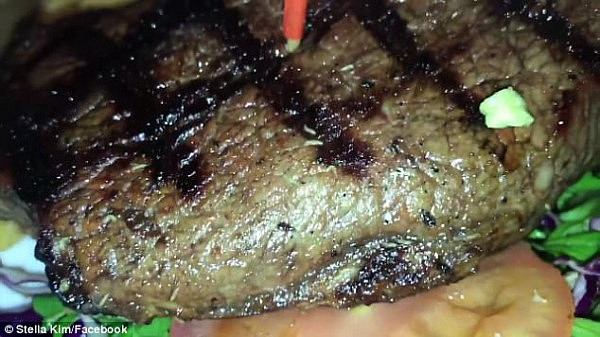 A Sydney couple claim they were served a steak with what appear to be maggots crawling throughout (pictured), ruining their appetite and anniversary