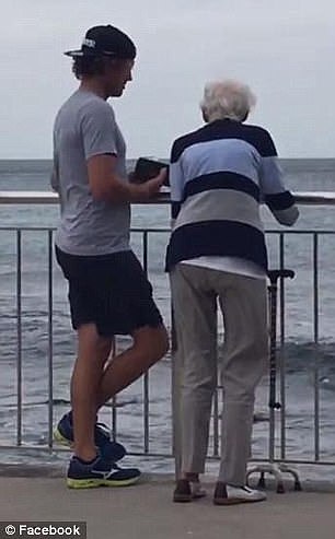 As they overlook the ocean the pair appear to be enjoying a conversation, while the elderly woman's walking stick rests up against the steel fence