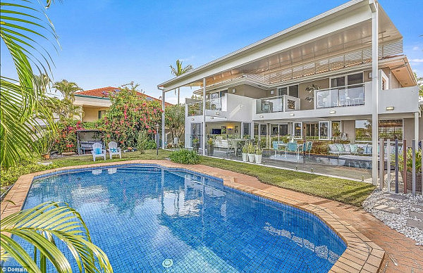 The four-bedroom home on the Gold Coast has a large undercover deck area leading out to a backyard with a massive swimming pool