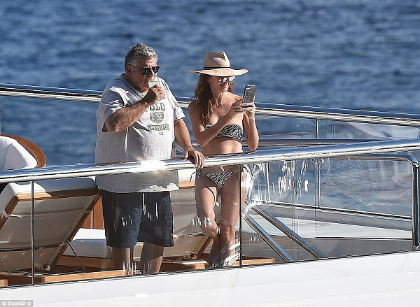 The finance king and his wife took a moment to record the picturesque coastline on their phones