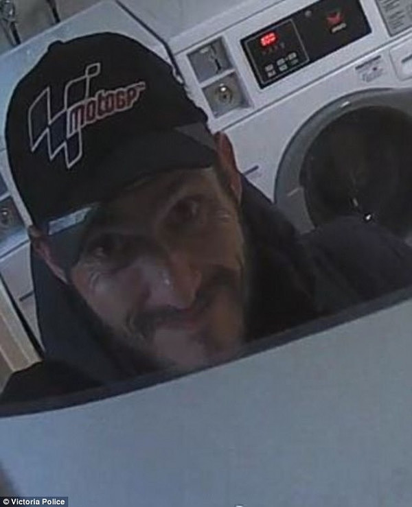 Police are on the hunt for a man (pictured) who offered a smug smirk to security cameras inside a Carlton laundromat on October 29