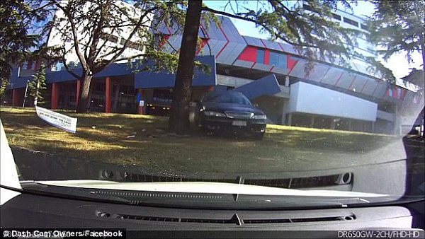 The video shows a dark blue Ford Fairlane come flying out of an underground carpark at a hospital in Melbourne