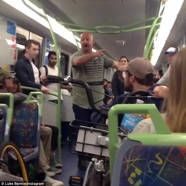 A brawl has broken out on a suburban train after a man was incensed by a group of young adults with share-bikes blocking the walkway