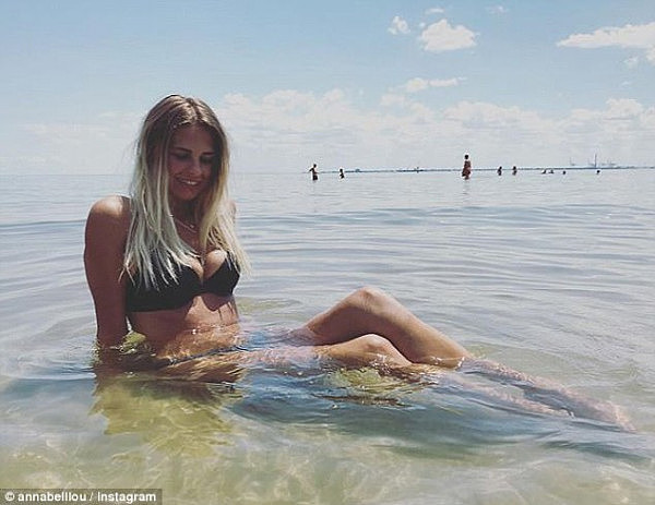 Light showers across the country should offset the steamy temperatures over the weekend (woman pictured bathing at Melbourne's St Kilda beach on Tuesday)