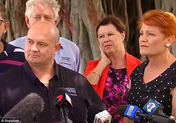 Fellow Townsville One Nation candidate Mark Thornton (left) confirmed to reporters his wife ran a sex shop, as Pauline Hanson looks on awkwardly