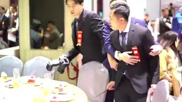 Angry: The wedding receptionist confronts the woman while holding a chopstick in hand