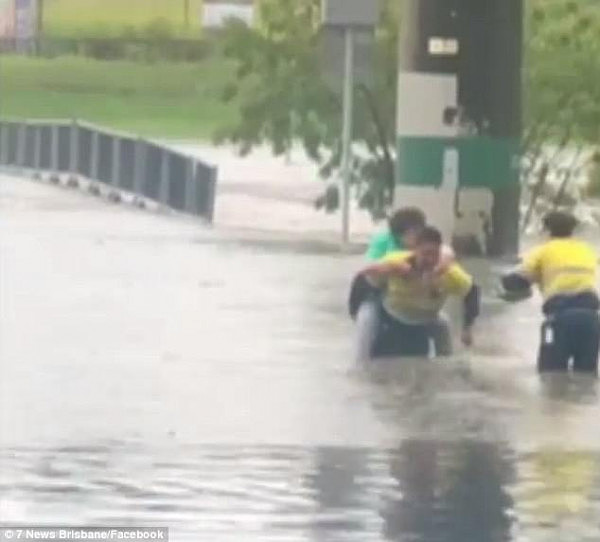 Video footage has emerged showing a man dragging an elderly woman from her car after it was caught up in the floods