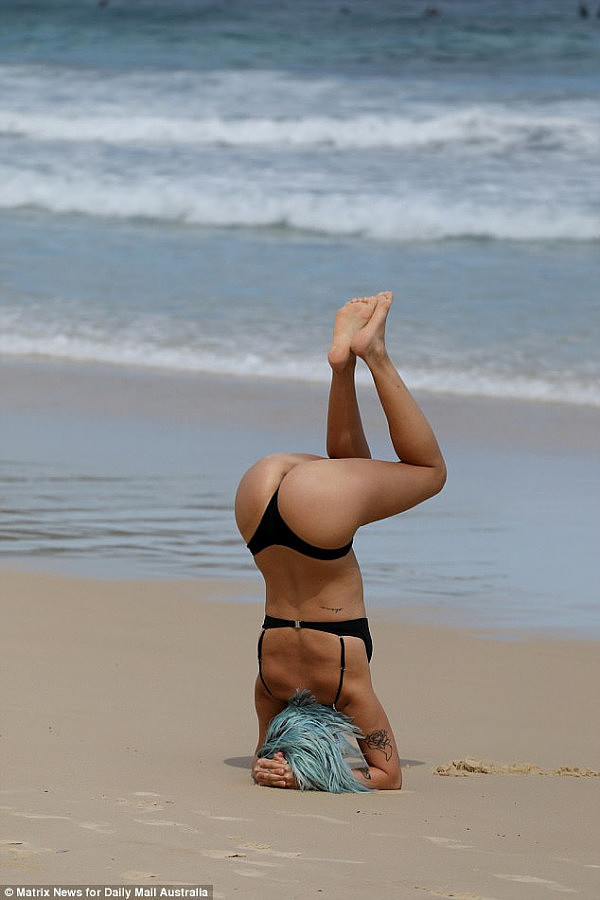 A woman was spotted performing headstands on Bondi Beach on Thursday, fitting right in with the famous suburb's 'hipster' yoga-loving vibe