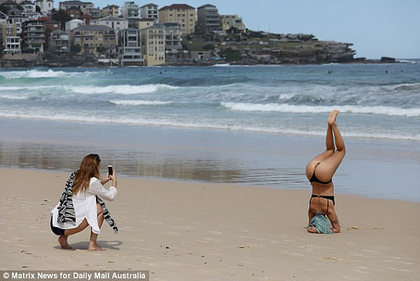 A friend crouched at her rear to capture the 'so Bondi' moment, kneeling down to ensure the crystal blue backdrop framed the photo perfectly
