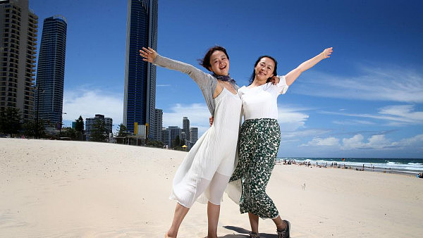 Chinese Tourists Qiqi Si and Nana Chao enjoy time on Surfers Paradise Beach. Picture: Adam Head