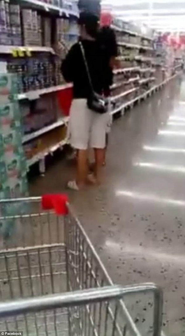A mother shopping for baby formula in a supermarket has spotted a couple she claims were 'hiding' tubs of powder