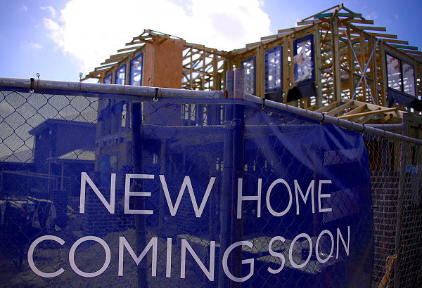 FILE PHOTO: A house under construction can be seen behind an advertising banner at a housing development located in the western Sydney suburb of Oran Park in Australia, October 21, 2017.   REUTERS/David Gray/File Photo
