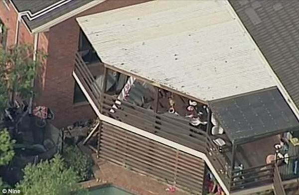 More than 30 people were standing on the timber balcony at the rear of a Melbourne home (pictured), in Doncaster East, when it collapsed