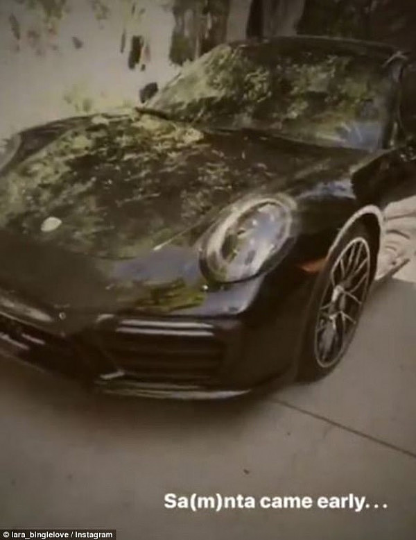 New wheels: Taking to Instagram on Monday, the entrepreneur flaunted the $200,000 black Porsche Cayman Sam had gifted her. 'Sa(m)ta came early!' Lara captioned the video she shared with her 490,000 followers.