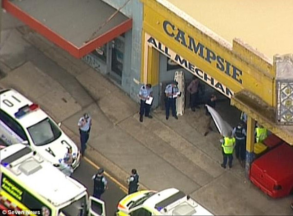 A two-year-old girl has died after being run over by her mother's car at the rear of a small business in Sydney's southwest (pictured)