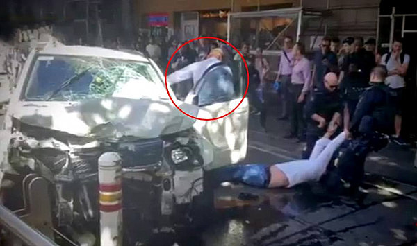 An off-duty police officer (circled) was praised for wrestling with Noori just 15 seconds after he crashed this Suzuki Grand Vitara four-wheel drive into a bollard outside Melbourne's Flinders Street Station during peak hour