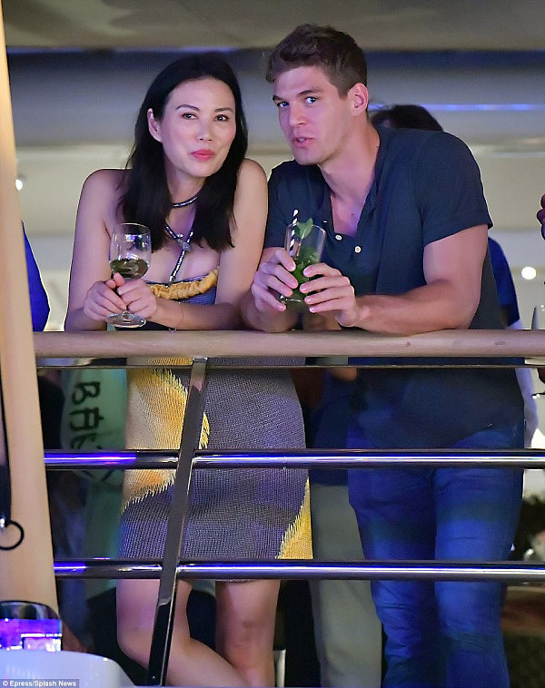 Wendi Deng has been pictured partying on a yacht with her 21-year-old model lover - four years after splitting from billionaire ex-husband Rupert Murdoch 