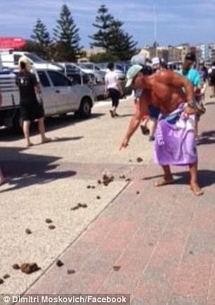Dimitri Moskovich (in purple towel) points at police horse droppings left on Bondi Beach