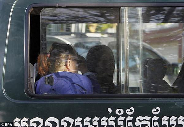 Charles (L) sits in a van while arriving at the Appeal Court in Phnom Penh, Cambodia, 08 January 2018
