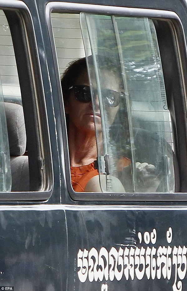 Davis-Charles sits in a car near the Municipal Court in June 2017 when she was on trial in Phnom Penh