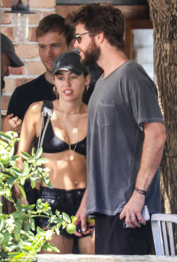 Holiday mode: Miley Cyrus (left) stepped out for lunch with Liam Hemsworth (right) in Byron Bay, NSW on Tuesday, after flying into Australia to spend the New Year with her fiancé