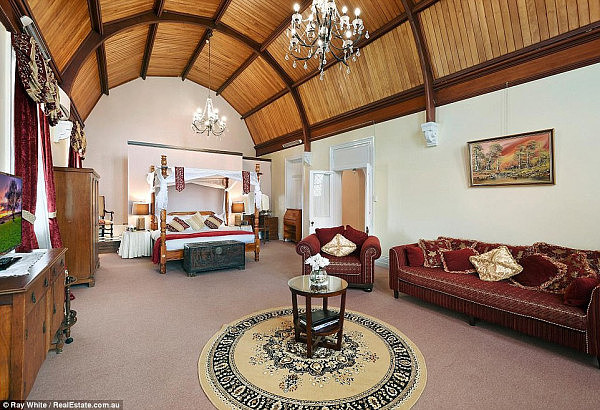 One of the bedrooms (pictured) in the Queensland property features high timber ceilings and dual chandeliers 