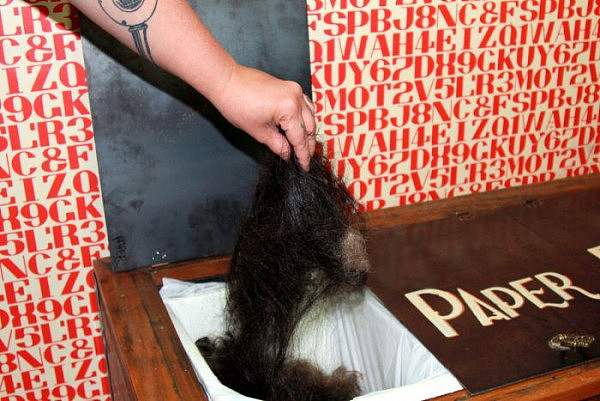 Hair from a hairdressing salon is put into a hair recycling collection bin.