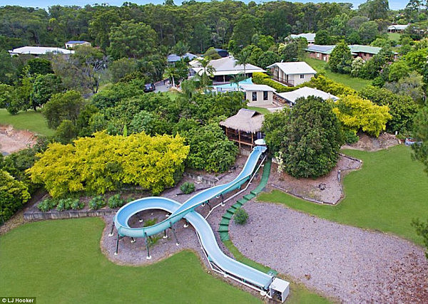 A Brisbane home featuring an amazing 50-metre water slide is up for sale (pictured), turning heads of potential buyers  