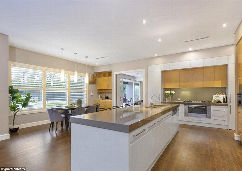Open plan: The modern kitchen houses a stainless steel fridge, ample cupboard space and a posh granite bench top