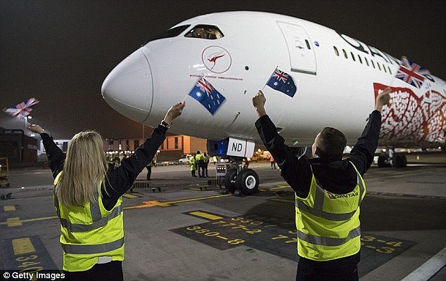 Qantas staff wave Australian and British flags at Heathrow airport on Sunday morning after 787-9 Dreamliner aircraft made a 17-hour flight from Perth 