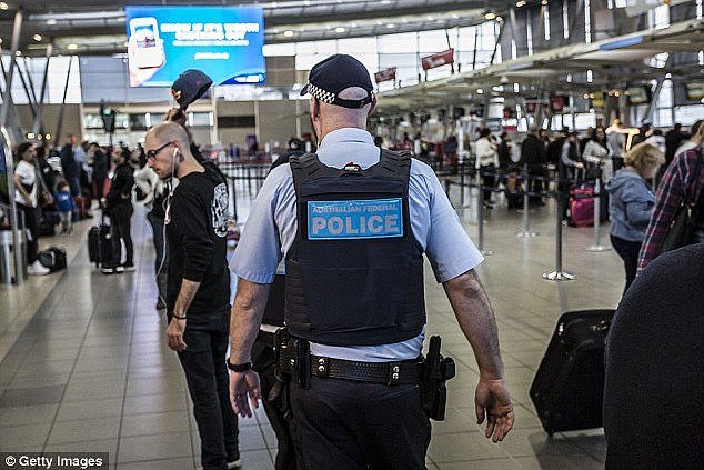 The AFP (officer pictured at Sydney Airport) will also focus on targeting encrypted messages sent over the internet to organise terror attacks