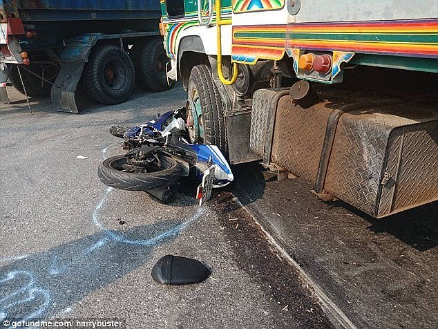 Mr Cross' mangled motorbike is pictured under a truck after the horror smash