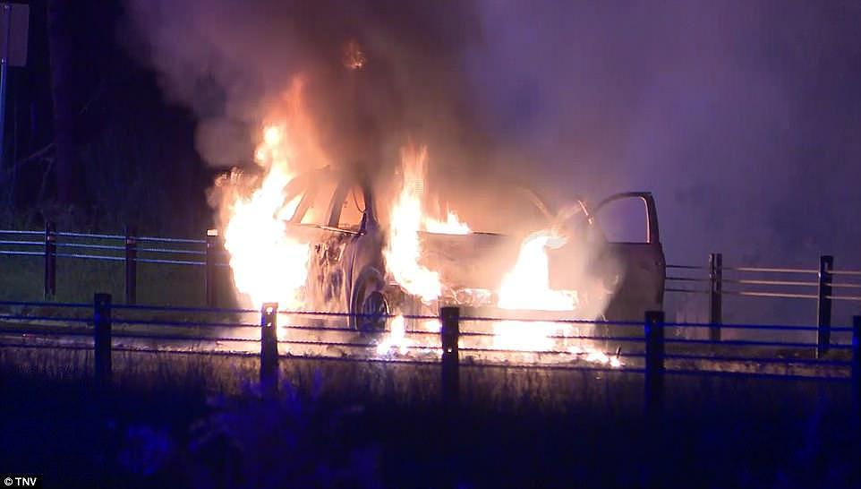 Raging inferno: An undercover police car filled with ammunition burst into flames on a busy motorway in Sydney last night