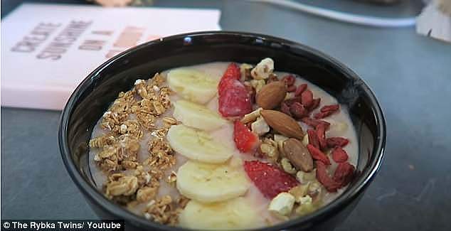 For lunch, the girls prepare their 'go-to' smoothie. They add bananas, strawberries, honey and almond milk to the blender. They pour the smoothie into a bowl, before adding fresh sliced up bananas and strawberries, almonds, walnuts, goji berries, muesli and chia seeds