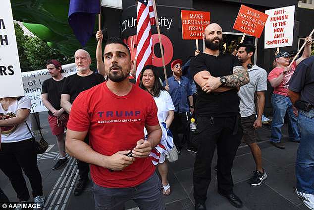 Conservative activist Avi Yemini (pictured), who obtained the footage from a spectator at the rally, said that 'hate crime' gesture on Saturday afternoon was an act of intimidation