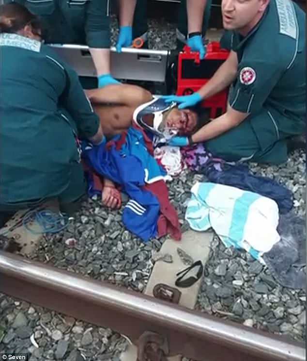 Mr Su, 17, is pictured lying on the tracks with blood on his face before paramedics rushed him to the Royal Perth Hospital at 4pm Thursday