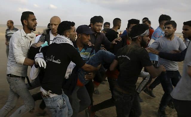 巴勒斯坦人抬着被枪击中的纳吉尔