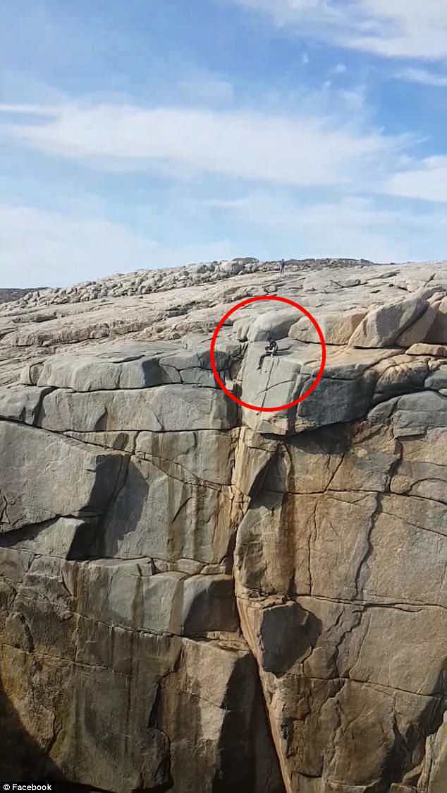 The tourist was seen hanging his legs over the edge of a 40-metre-high cliff face at The Gap in Albany in Western Australia