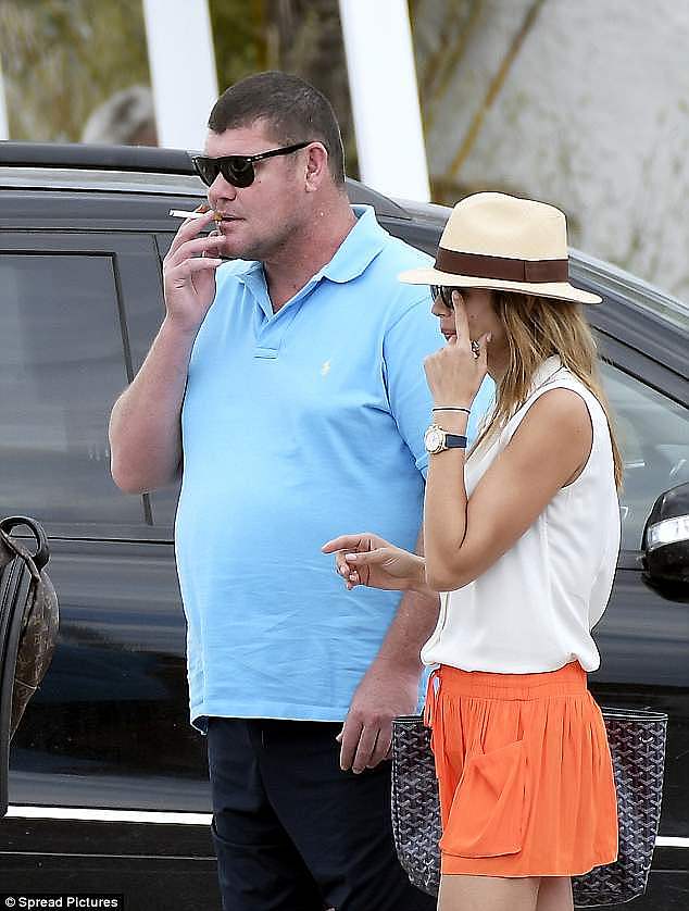 Bad habit: James dressed casually in sandals, black shorts and a blue polo shirt, and was seen smoking an unhealthy cigarette