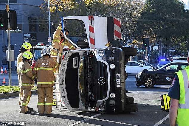 Two paramedics inside the vehicle at the time were taken to hospital with minor injuries 