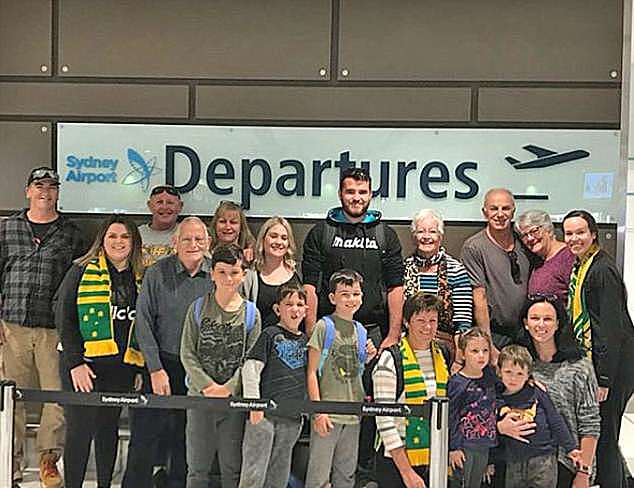 The huge fan club posed at the departures lounge of Sydney Airport before jetting off to Russia