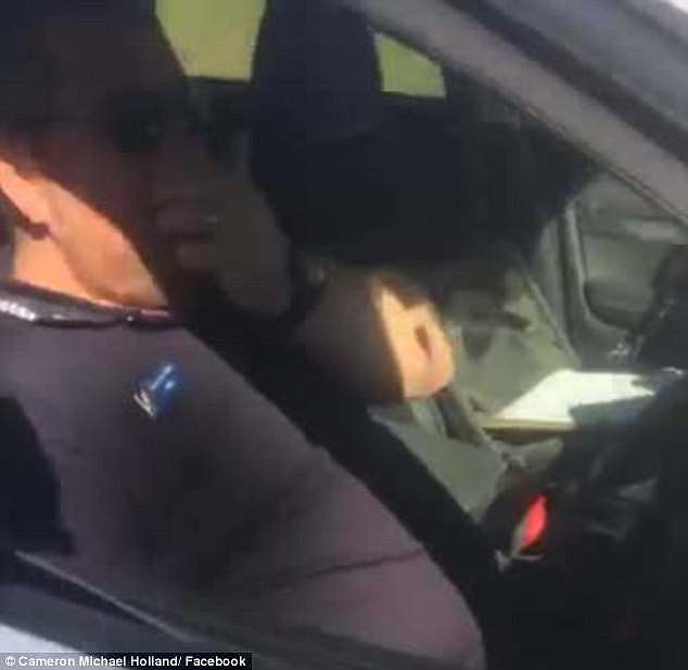 This is the incredible moment a police officer was caught sleeping on the job after he dozed off trying to fine speeding cars at a road in Queensland, north of Brisbane (pictured)