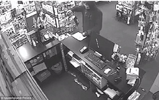 Footage has emerged of the chilling moment a brazen criminal with a knife robs an adult store