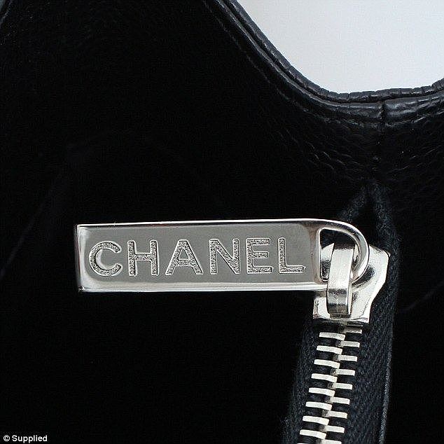 On the genuine Chanel bag (pictured), the engraving of CHANEL on the zipper pull is very crisp and evenly spaced