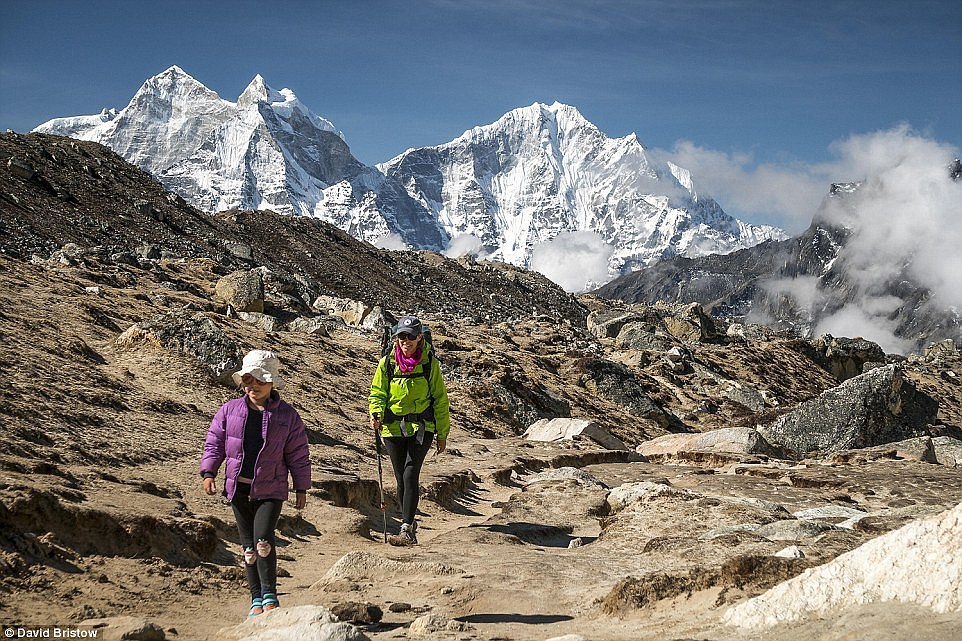 The adventurous youngster (pictured with her mother, Ms Lawson) did not want to turn back once and kept 'plodding along' as she looked at flowers, wildlife and was treated with chocolates by passing hikers in May