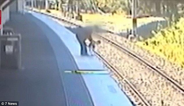 A father and his toddler had to scramble to safety to avoid being hit by a train moments after this footage was taken at Oatley station