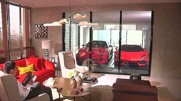 A new Melbourne apartment will allow tenants to park their cars in their living room enclosed in a glass-walled double garage. (Pictured) A tenant showing off his sky-high garage in Singapore