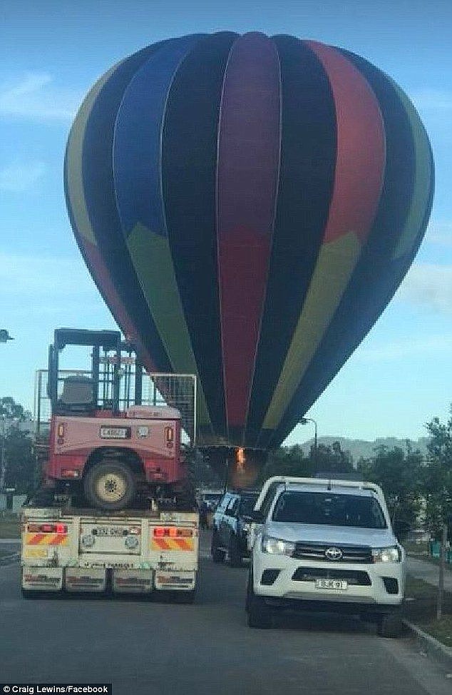 A hot air balloon caused a stir when it landed between cars in the middle of a local road