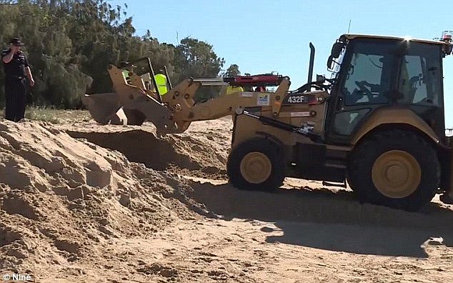 A front end loader was also brought in to help with the rescue operation, as it looked like a tree would have to be uprooted to get him out safely