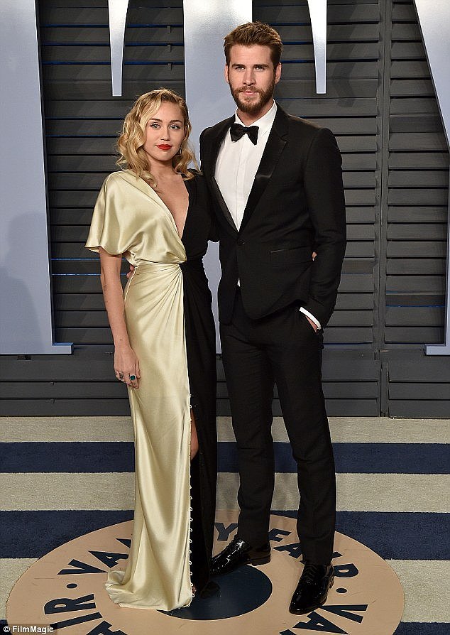 'He is heartbroken': Miley Cyrus, 25, and Liam Hemsworth, 28, have reportedly called off their wedding because the singer is not ready for a baby, OK! Australia claimed on Thursday. The couple are pictured at the 2018 Vanity Fair Oscar party in Beverly Hills in March 2018
